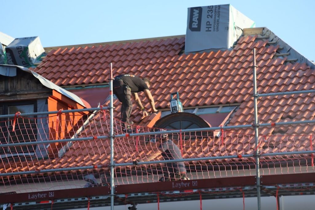 Buy Roofing Leads - contractor working on storm-damaged roof