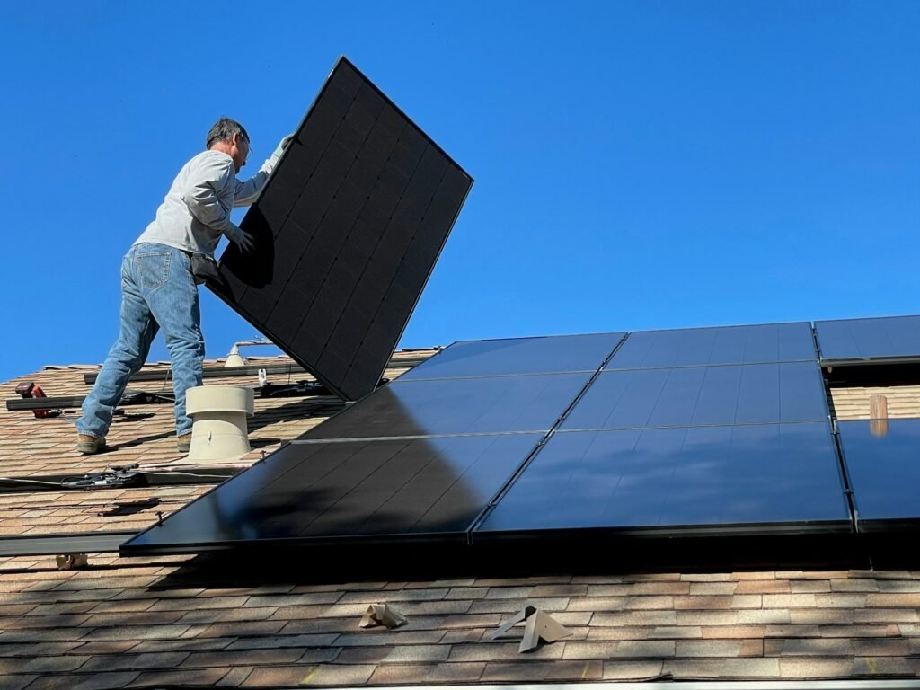 Technician installing solar panel - cost of solar leads